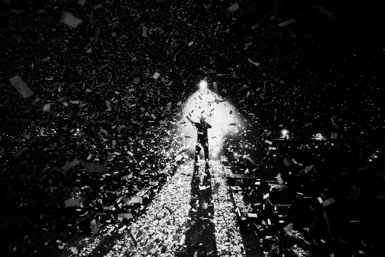 Wide event venue scene with stage infrastructure and attendee zones